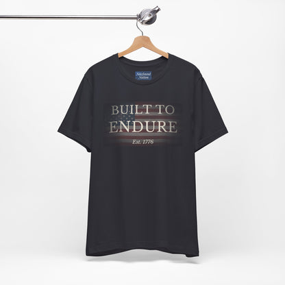 Built to Endure T-Shirt - Patriotic Est. 1776 Tee displayed on a hanger with minimalist design.